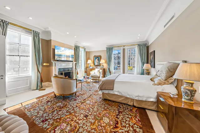 a living room with fireplace furniture and a large window