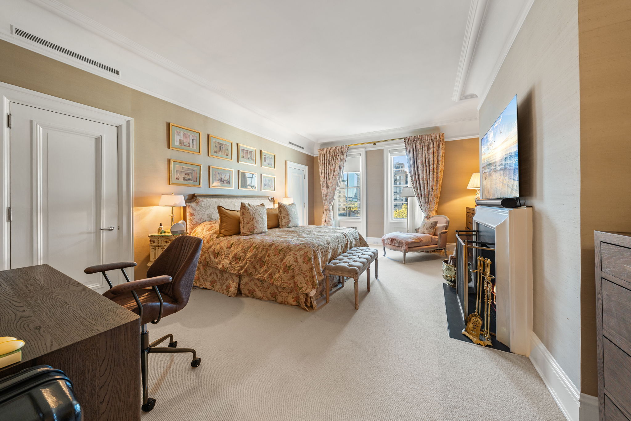 32 East 64th Street, Unit 9W Manhattan, NY 10065 - Photo 12 of 16 a bedroom with a bed gym equipment and a large window