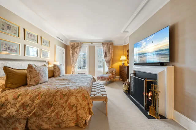 a bedroom with a bed gym equipment and a large window