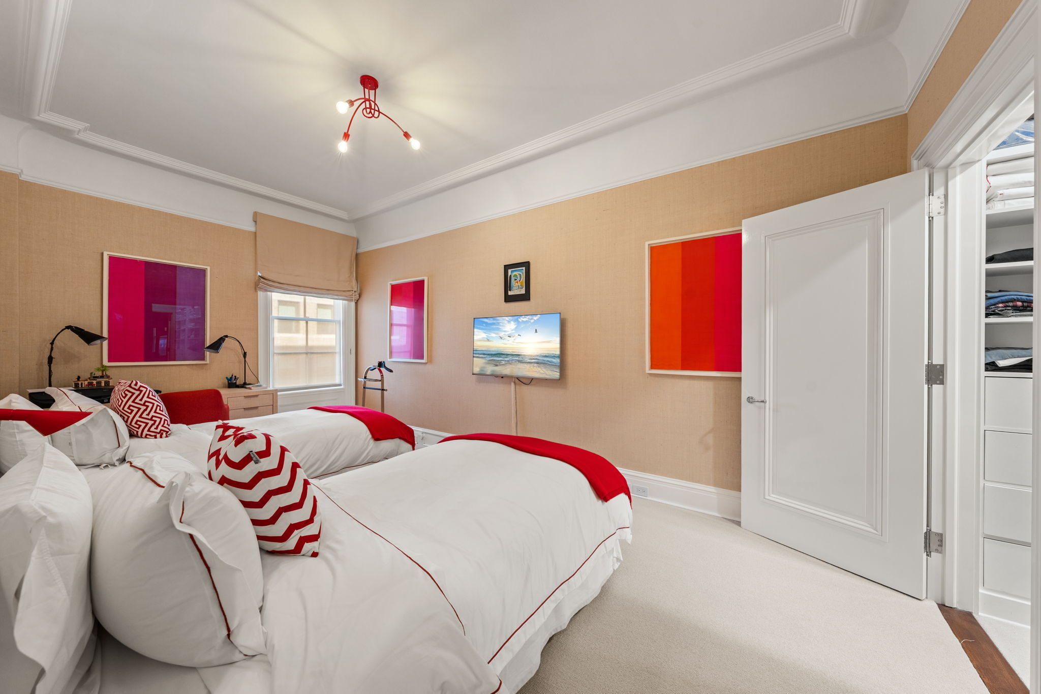 32 East 64th Street, Unit 9W Manhattan, NY 10065 - Photo 14 of 16 a bedroom with a bed and a chandelier