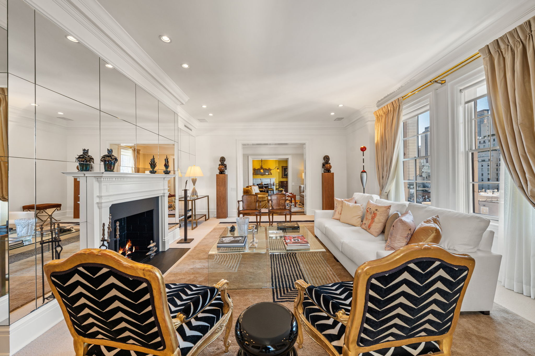 32 East 64th Street, Unit 9W Manhattan, NY 10065 - Photo 4 of 16 a living room with furniture and a fireplace