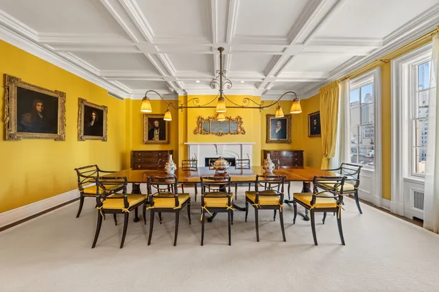 a view of a dining room with furniture and a chandelier