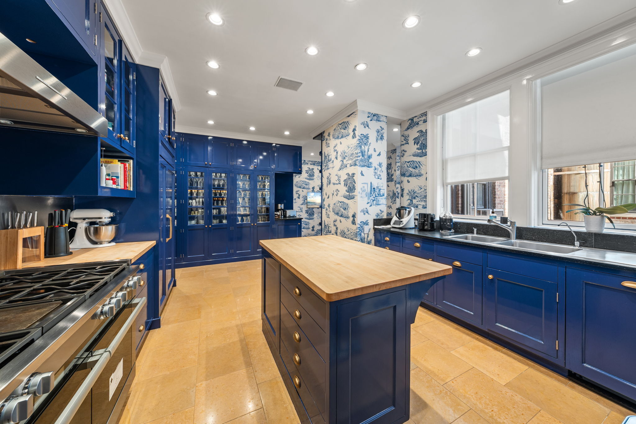 32 East 64th Street, Unit 9W Manhattan, NY 10065 - Photo 8 of 16 a kitchen with counter top space a sink and appliances