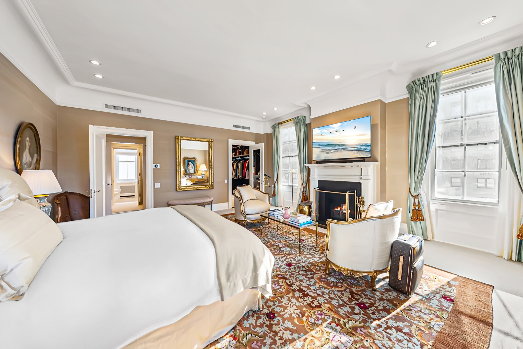 32 East 64th Street, Unit 9W Manhattan, NY 10065 - Photo 9 of 16 a living room with fireplace furniture and a large window