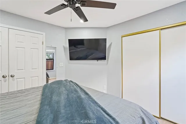 a bedroom with a bed and a flat screen tv