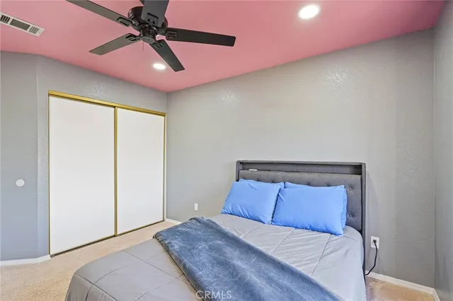 a view of patio with table and chairs under an umbrella with a small yard
