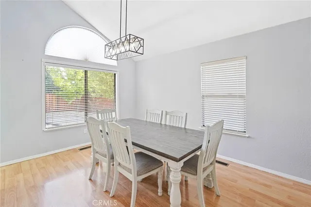 a view of a dining room with furniture wooden floor and a chandelier