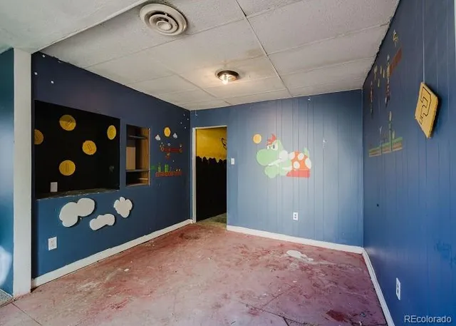 a view of an empty room with window and stairs