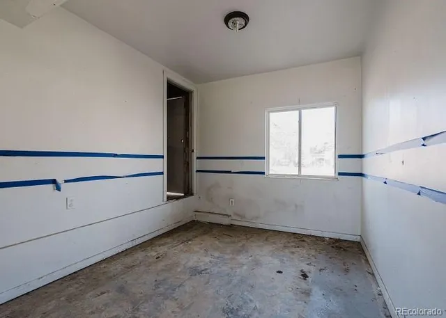 a view of storage and utility room with closet