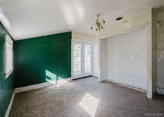 a view of a big room with windows and chandelier fan