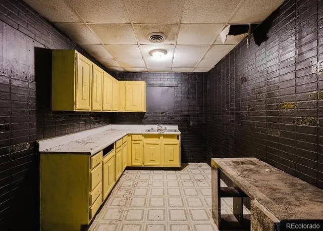 a bathroom with a granite countertop sink a toilet and mirror
