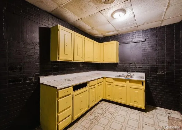 a kitchen with a sink window and cabinets