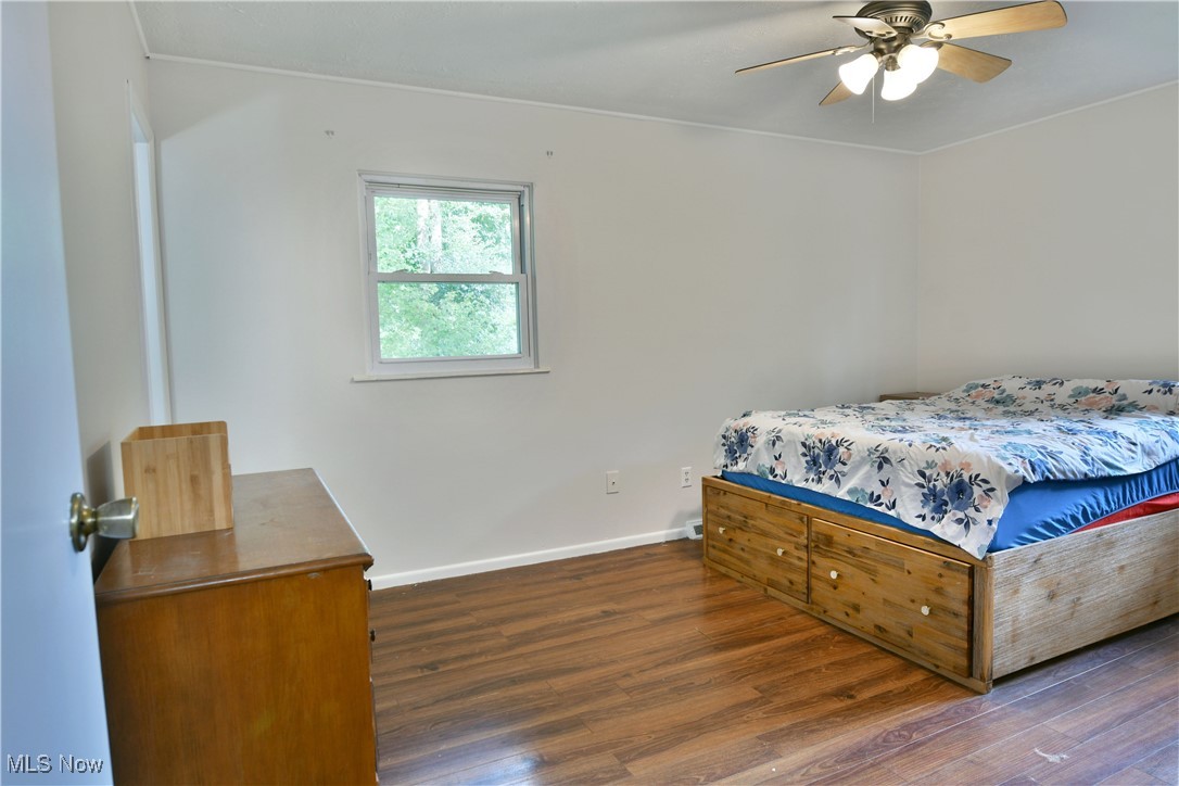 234 Howland Wilson Road Northeast Warren, OH 44484 - Photo 19 of 37 Bedroom featuring wood finished floors and a ceiling fan