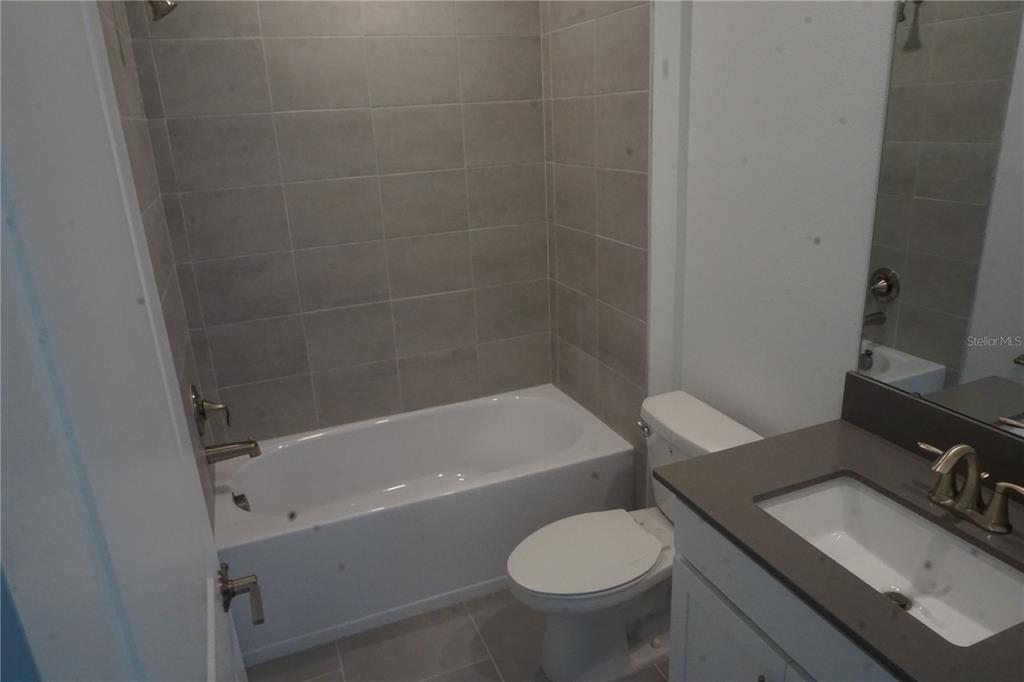 5704 Stephens Road St. Cloud, FL 34771 - Photo 9 of 12 a bathroom with a sink toilet and shower