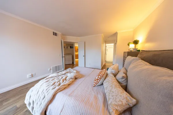a bedroom with a bed and a night stand