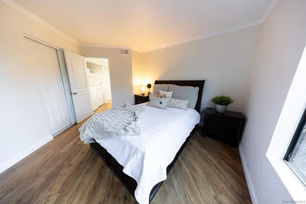 a bed sitting in a bedroom next to a window