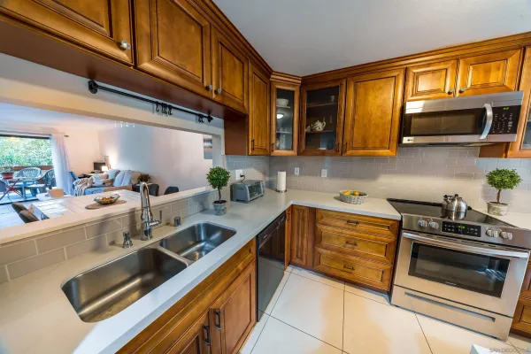 a kitchen with stainless steel appliances a stove a sink and cabinets