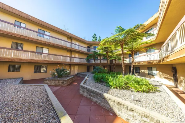 a front view of a building with a garden