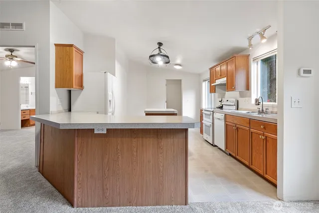 a kitchen with stainless steel appliances a sink stove and cabinets