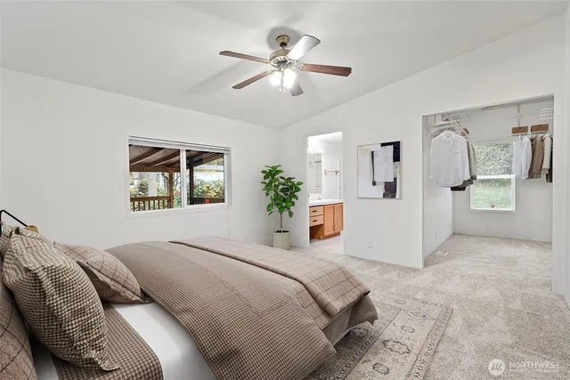 a bedroom with a large bed a chandelier and a couch