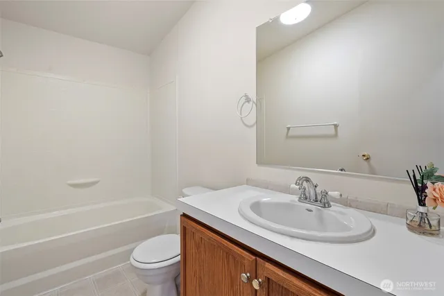 a bathroom with a sink toilet vanity tub and shower