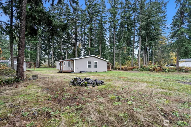 a wooden house with tall trees