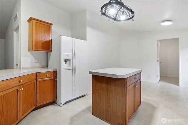 a kitchen with stainless steel appliances a refrigerator and cabinets