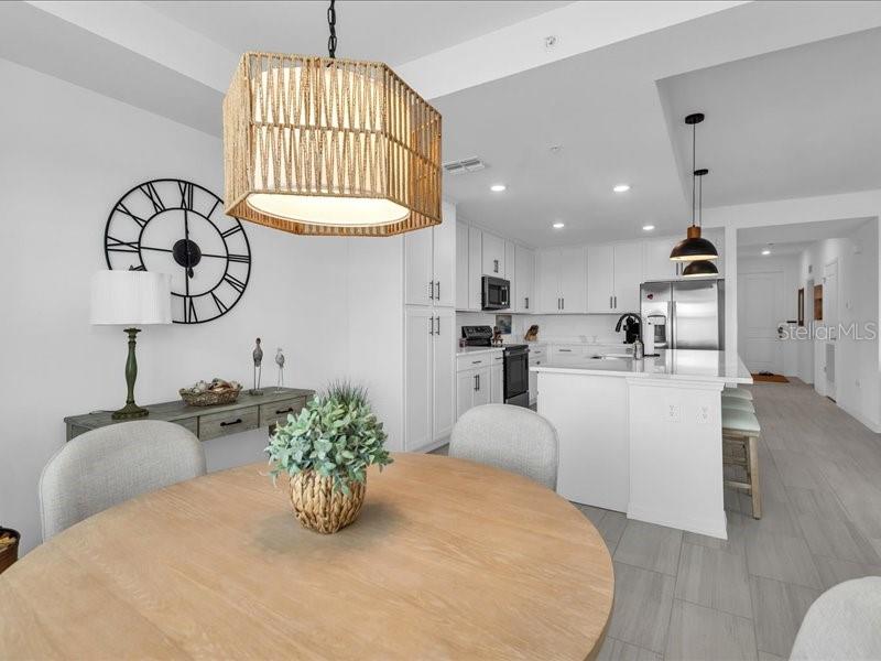 19116 Scallop Loop, Unit 303 Lakewood Ranch, FL 34211 - Photo 13 of 32 a kitchen with stainless steel appliances kitchen island granite countertop a white cabinets a stove and a sink