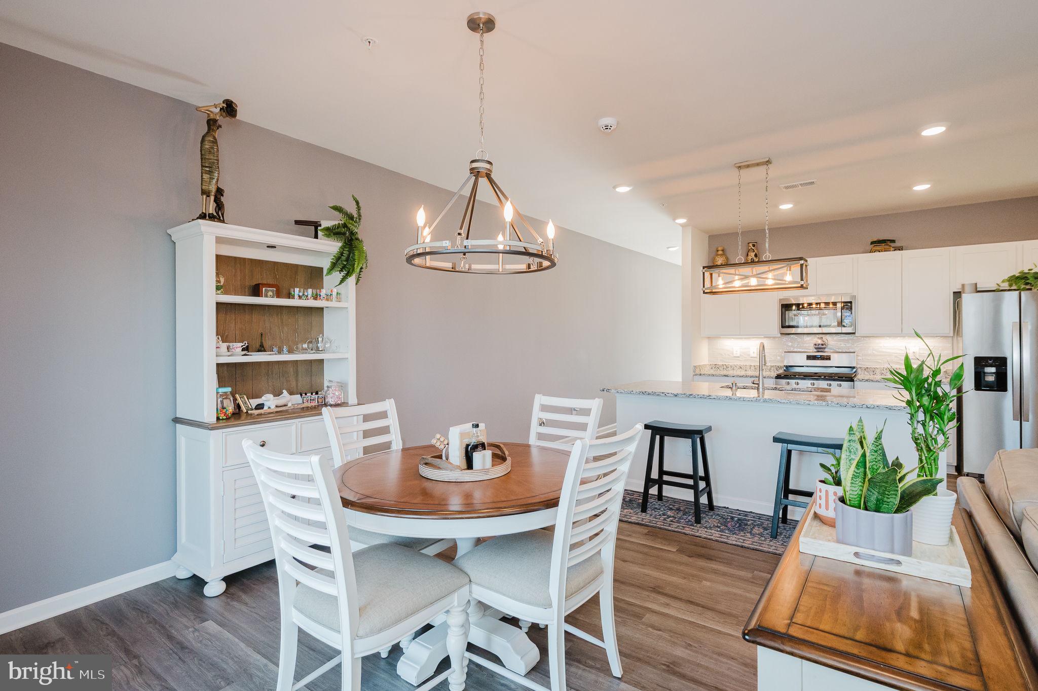 668 Beadlilly Way Joppa, MD 21085 - Photo 13 of 47 a view of a dining room with furniture a chandelier and wooden floor