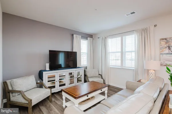 a living room with furniture and a white wall