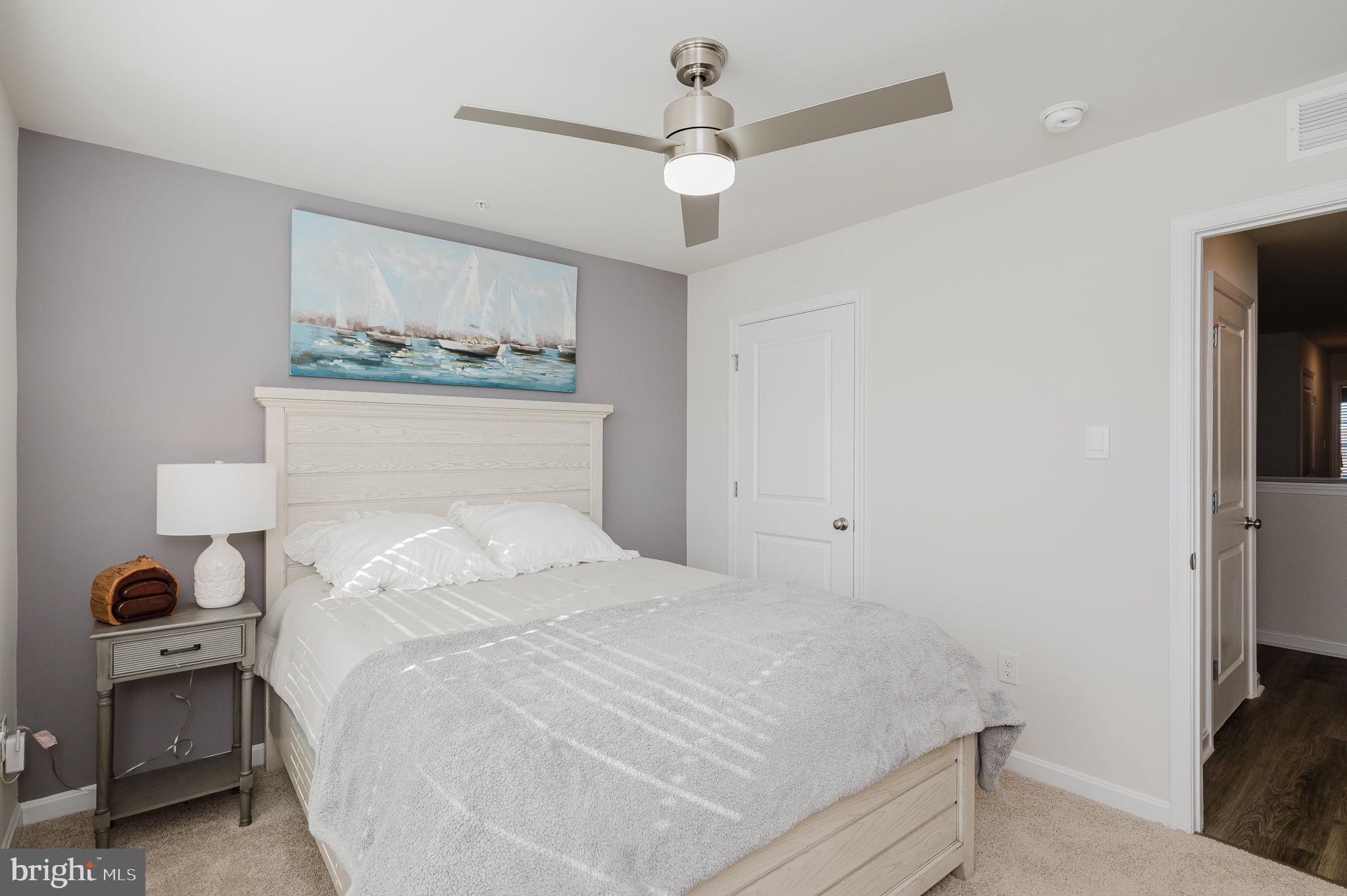 668 Beadlilly Way Joppa, MD 21085 - Photo 29 of 47 a bedroom with a bed and a chandelier