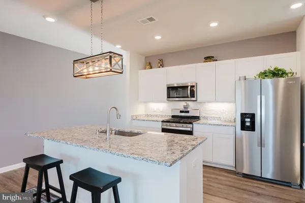 a view of a kitchen island wooden floor and living room
