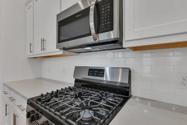 a kitchen with a stove and a microwave