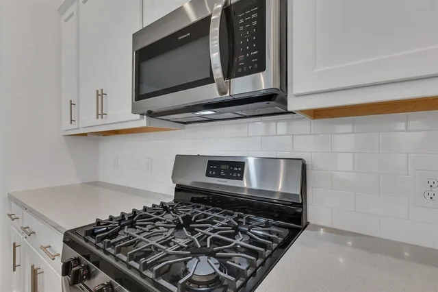 a kitchen with a stove and a microwave