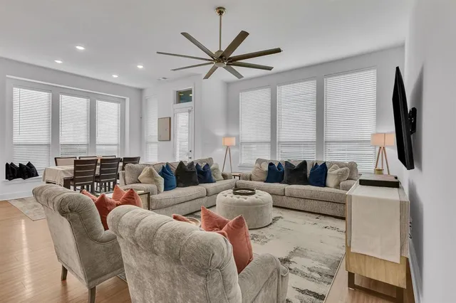a living room with furniture a large window and a flat screen tv