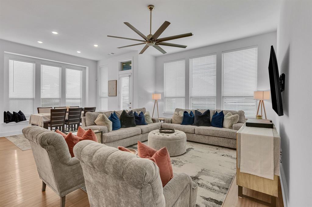 1817 Lockhart Drive Forney, TX 75126 - Photo 17 of 32 a living room with furniture a large window and a flat screen tv