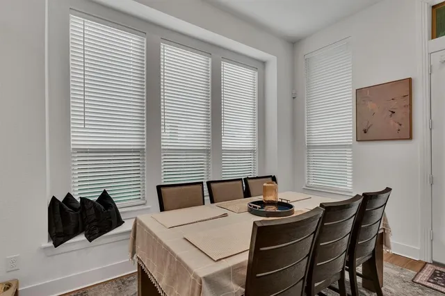 a kitchen with a table chairs and a window