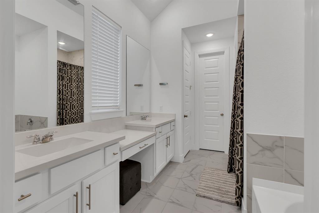1817 Lockhart Drive Forney, TX 75126 - Photo 23 of 32 a spacious bathroom with a double vanity sink a mirror and a bathtub