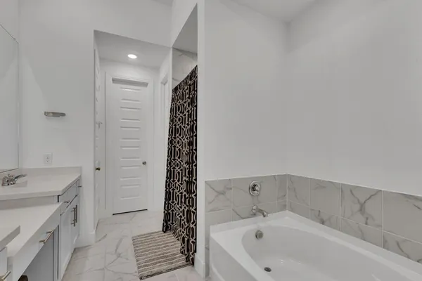 a bathroom with a bathtub and a sink