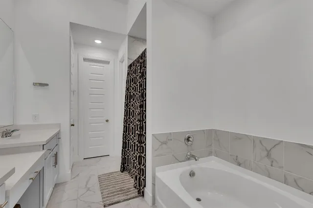 a bathroom with a bathtub and a sink