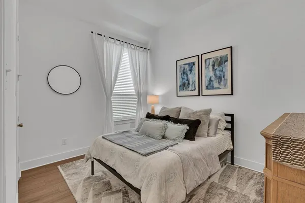 a bedroom with a bed and a window