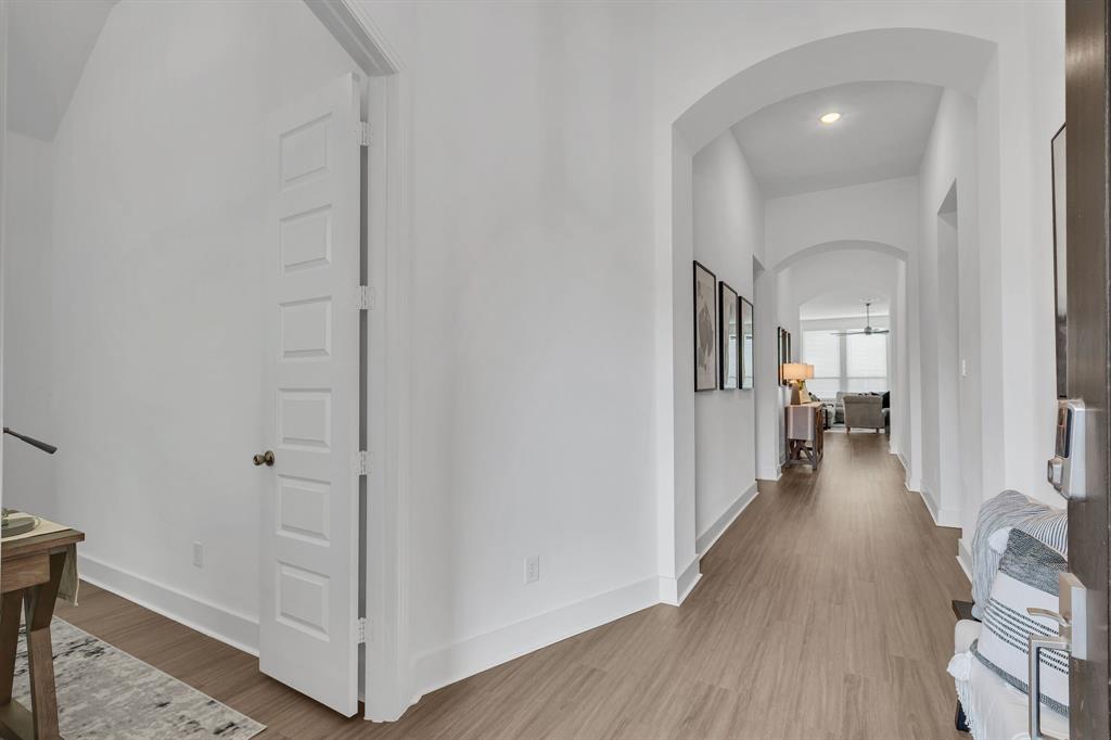 1817 Lockhart Drive Forney, TX 75126 - Photo 4 of 32 a view of a hallway with wooden floor and staircase
