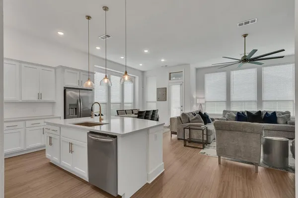 a large white kitchen with a large window
