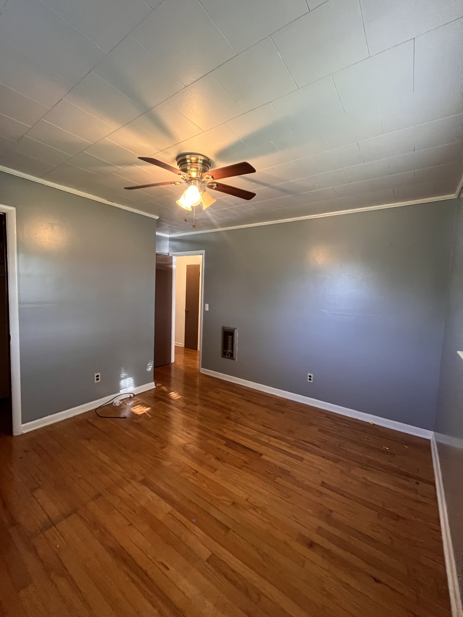 1035 North 3rd Street Pulaski, TN 38478 - Photo 12 of 17 an empty room with wooden floor and windows