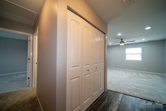 106 Gant Circle, Unit G Streamwood, IL 60107 - Photo 2 of 12 a view of hallway with wooden floor and a bathroom