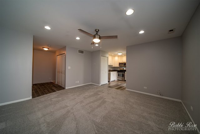 106 Gant Circle, Unit G Streamwood, IL 60107 - Photo 5 of 12 a view of an empty room with a kitchen