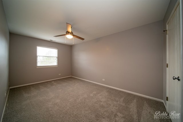 106 Gant Circle, Unit G Streamwood, IL 60107 - Photo 9 of 12 an empty room with a window