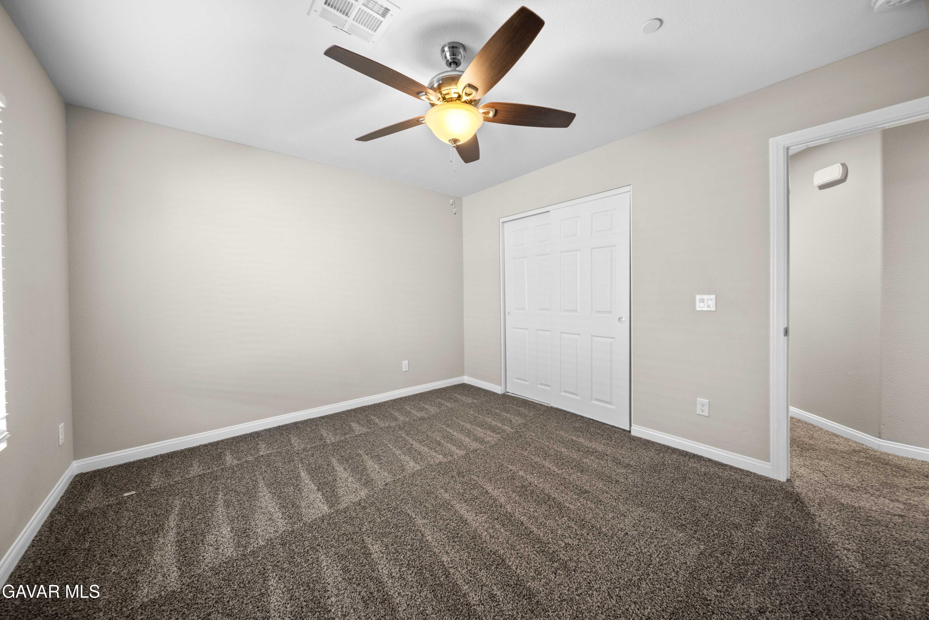 2009 Jenner Street Lancaster, CA 93535 - Photo 12 of 15 an empty room with closet and ceiling fan