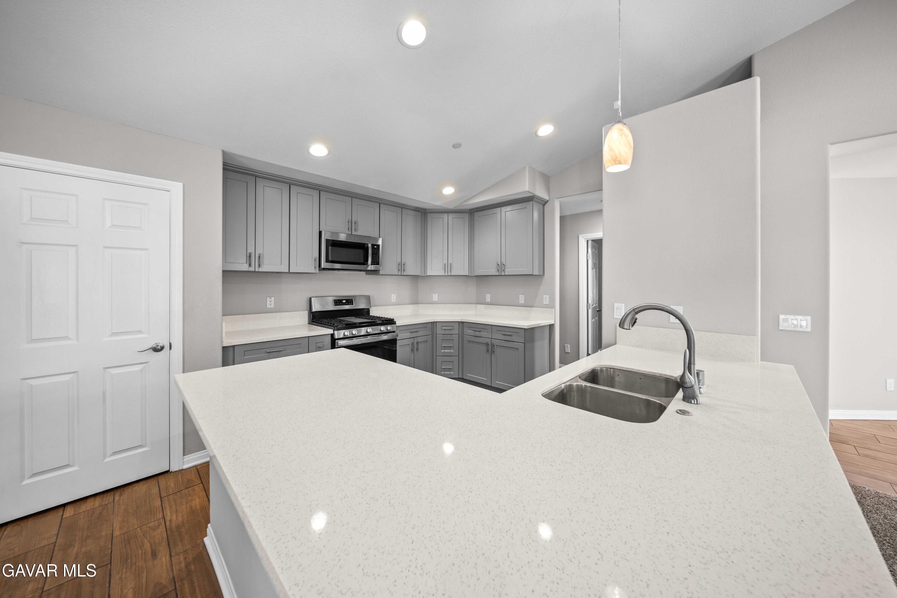 2009 Jenner Street Lancaster, CA 93535 - Photo 4 of 15 a kitchen with sink a refrigerator and cabinets