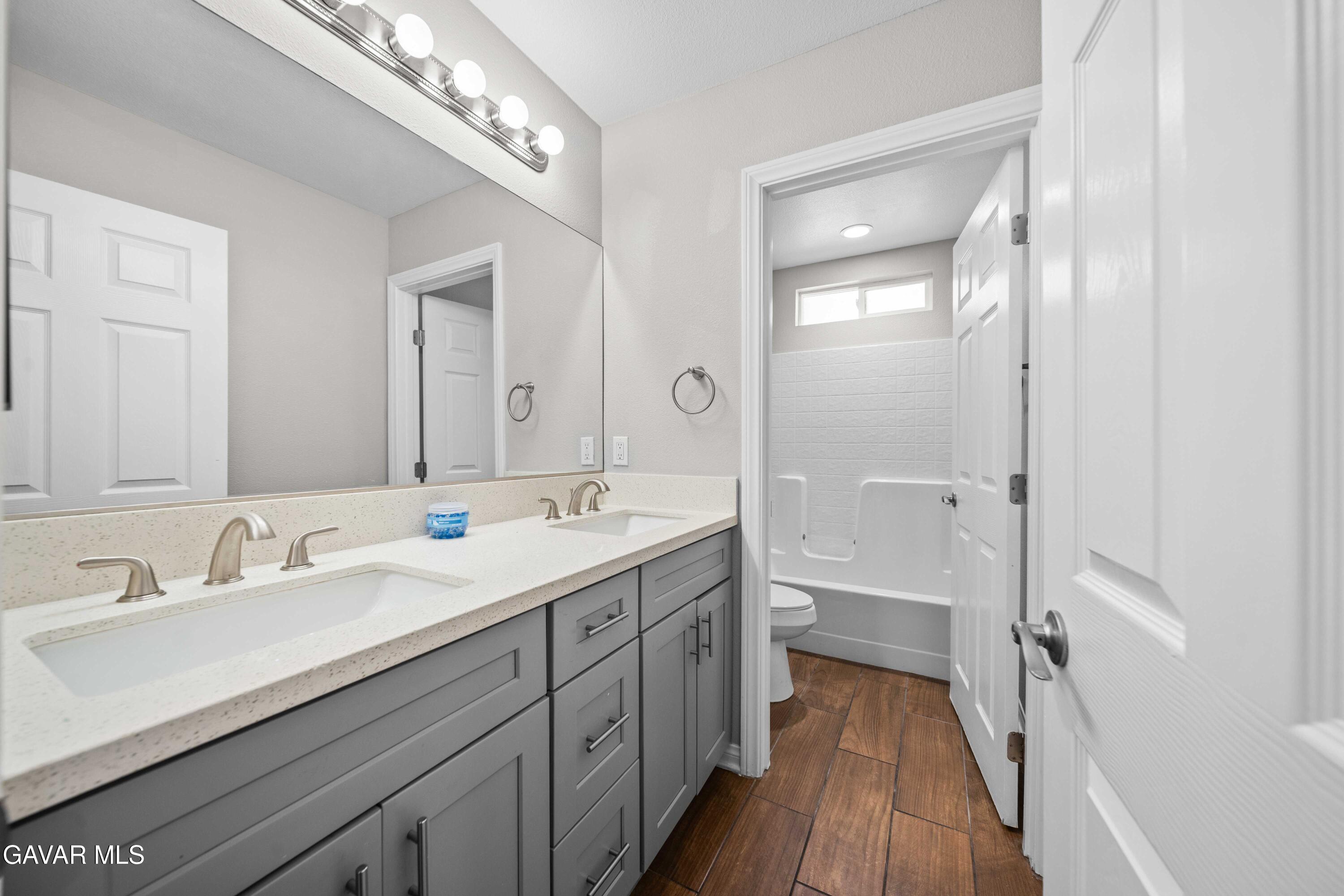 2009 Jenner Street Lancaster, CA 93535 - Photo 10 of 15 a spacious bathroom with a double vanity sink mirror and double
